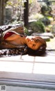 A woman laying on a wooden deck in a garden.