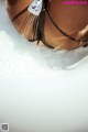 A close up of a woman in a bikini in the water.