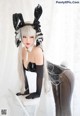 A woman in a bunny costume sitting on a chair.