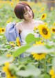 A woman standing in a field of sunflowers.