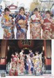 A group of women in kimonos standing in front of a building.