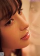 A close up of a woman's face in front of a mirror.