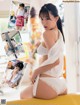A woman in a white shirt and panties sitting on a yellow couch.